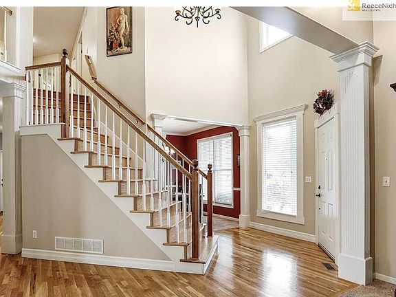 Dramatic entry with hardwood staircase.