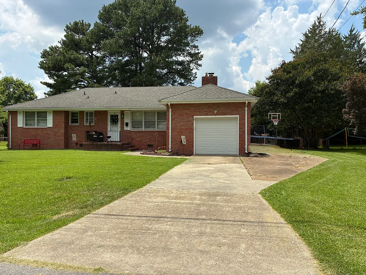 Picture of driveway showing side driveway which allows easy daily use of two vehicles. - 245 Bowman Rd