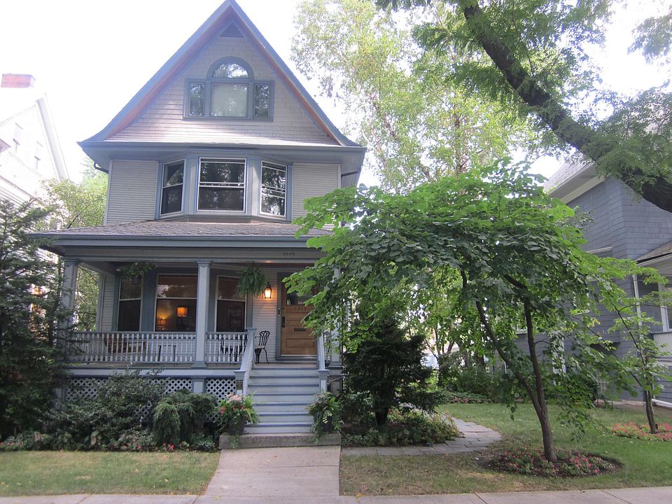 Front porch has a swing, cafe table and chairs.