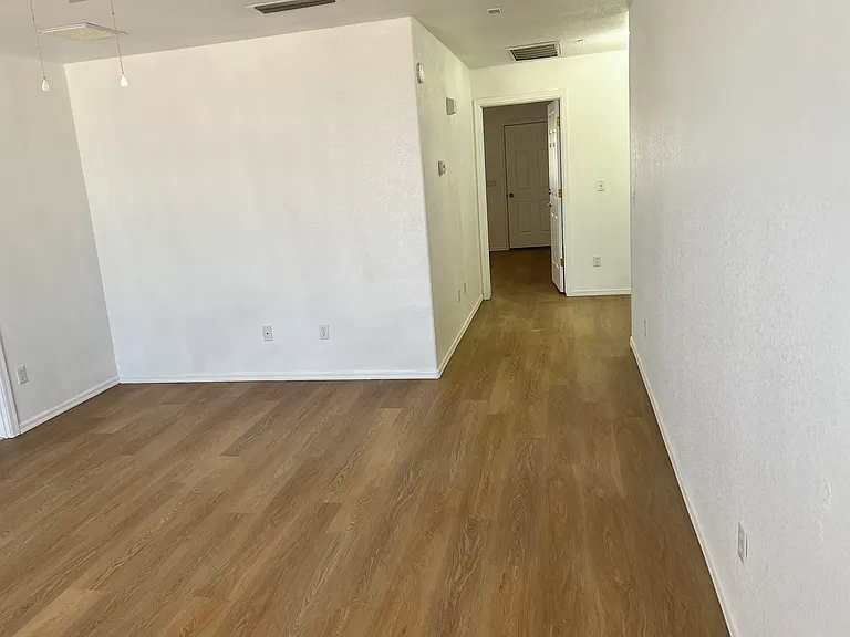 Living room of one bedroom unit facing bedroom