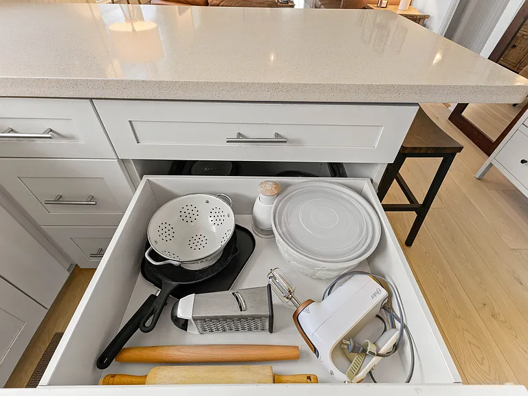 The kitchen is open to the living room and features plenty of storage and counter space, a ceiling fan, full size refrigerator with water station, oven, microwave and dishwasher. The kitchen is fully equipped.