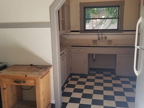 Kitchen: Cabinets, Refrigerator, and Sink area