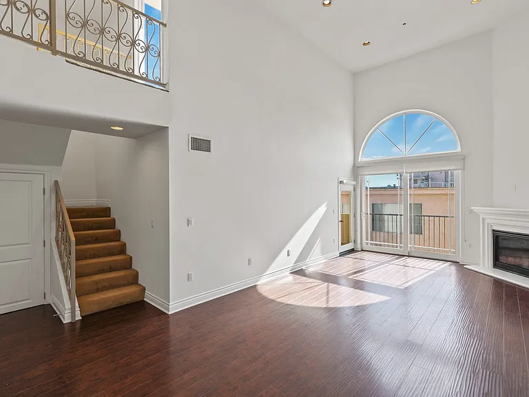 Open-Concept Dining and Living Room with Electric Fireplace and Patio