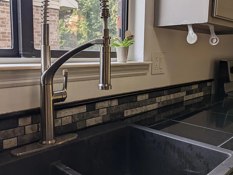 Tile backsplash and modern sink.