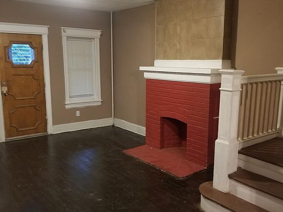 Living room hard wood floors with original and fire place