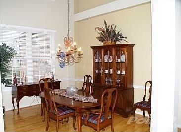 The Dramatic Formal Dining Room has a 2-story ceiling with beautiful Patina chandelier. Decorative c