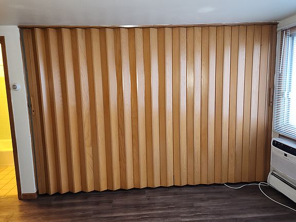 bed and closet area with divider wall closed