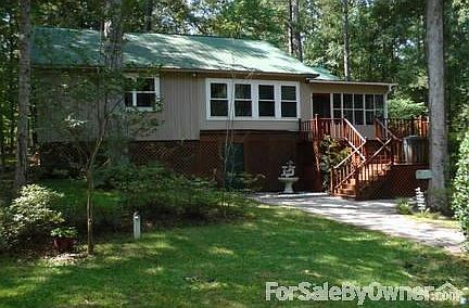 Side View
						:
						This side of the house faces the circle driveway. The green door opens to a shop