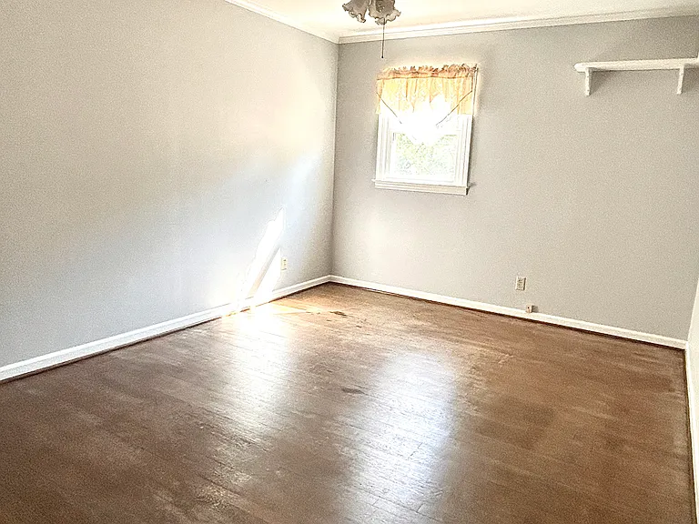 one of the bedrooms in the upstairs with window and its own closet.