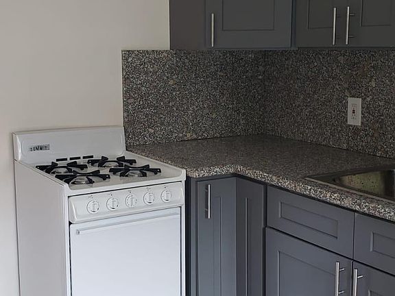 NEW kitchen with granite counter top and new gas stove