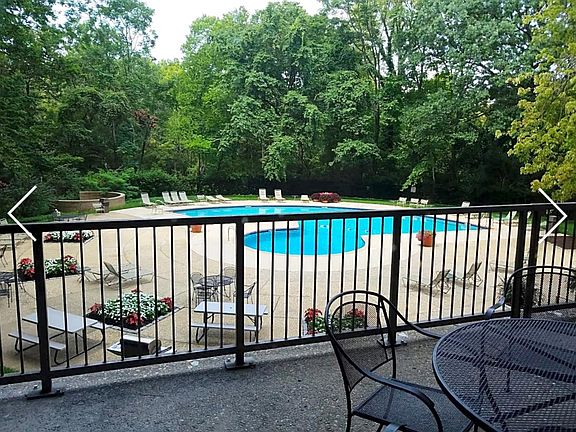 Outdoor pool with grilling area and tables
