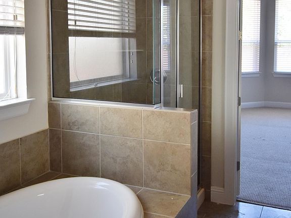 Soak in this oversized tub and enjoy the modern stand up shower