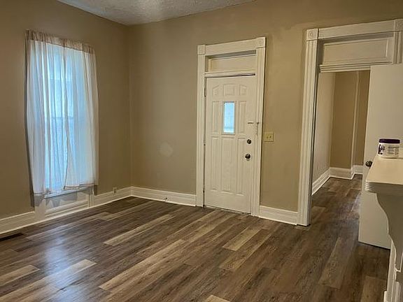 Living room entry door looking into larger Bedroom