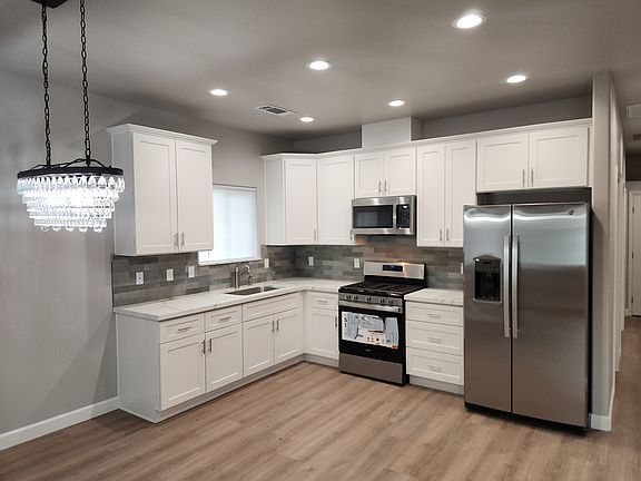 Kitchen with new stainless steel appliances.