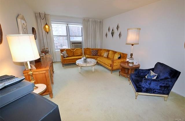 The large sunny living room opens to the large dining foyer.