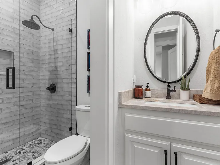Modern 4th-floor full bathroom featuring a walk-in shower and chic matte black accents.