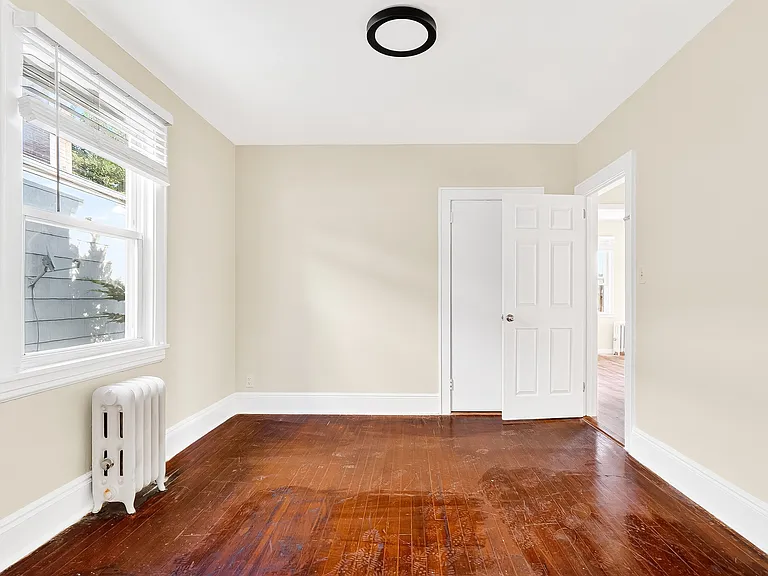 Bedroom with hardwood floors.