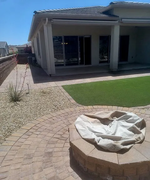 back yard looking toward house, gas firepit in foreground, large patio