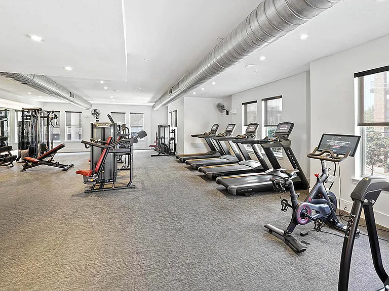 Fitness center with cardio machines and weight equipment.