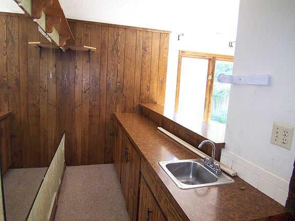 Basement Bar Area with huge windows and door out to unique private sunken patio and yard.