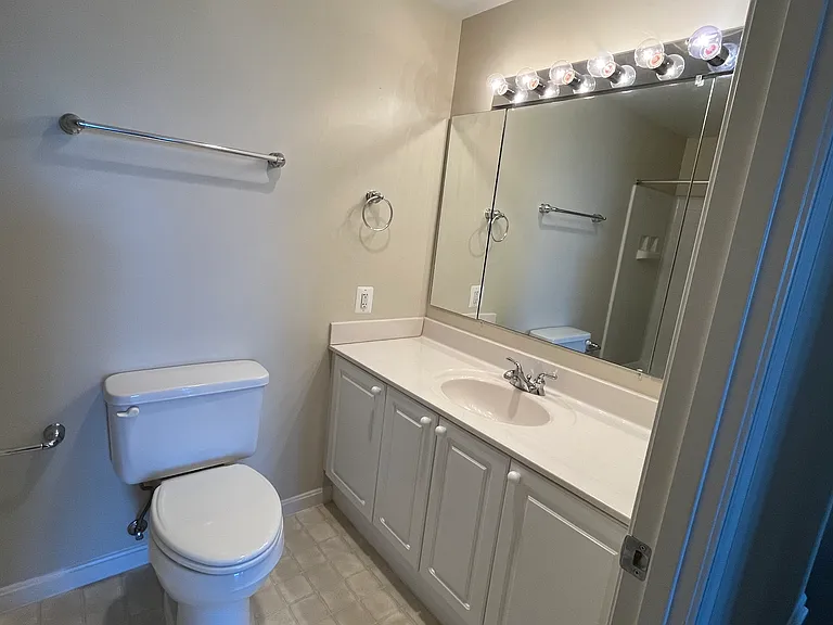 Bathroom #2 (hall bath) with sink, toilet, and tub reflected in mirror