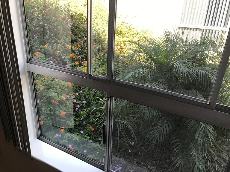 Guest bedroom downstairs looking out toward garden area and waterfall 2x2