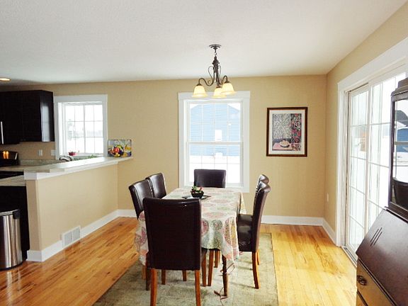 Hardwood flooring in dining area and a sliding glass door to the patio.