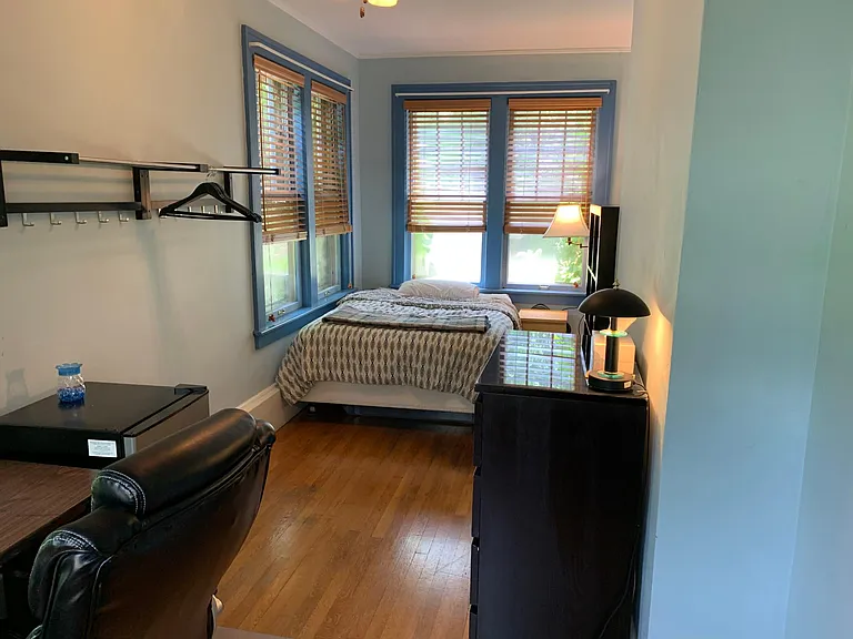 1st floor - east facing sun room / bedroom w/ hardwood floors; premium fully adjustable leather chair