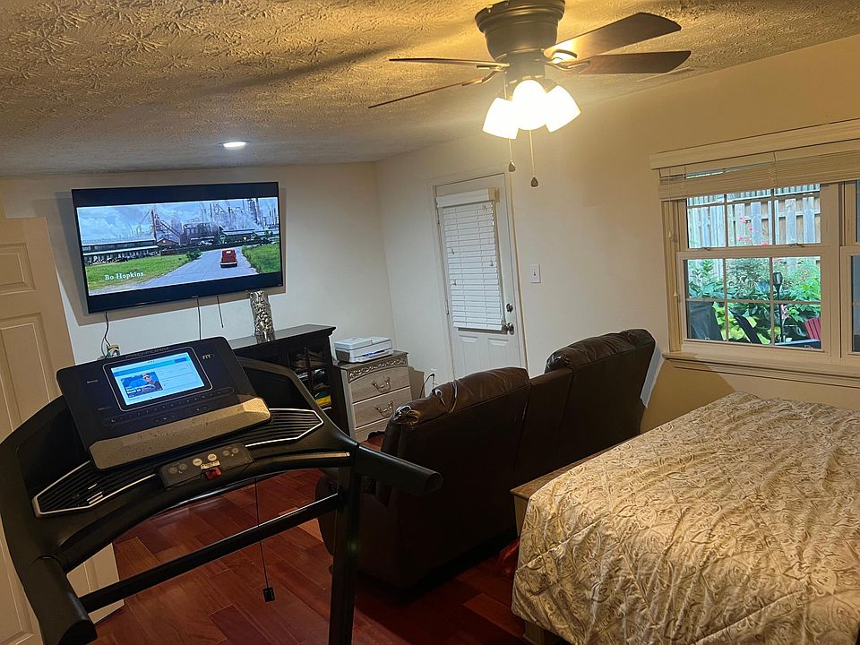 Basement Bedroom #4 with Roku 65" 4k HDTV, Double Recliner Sofa, Treadmill, Queen Bed, Dresser and Mirror