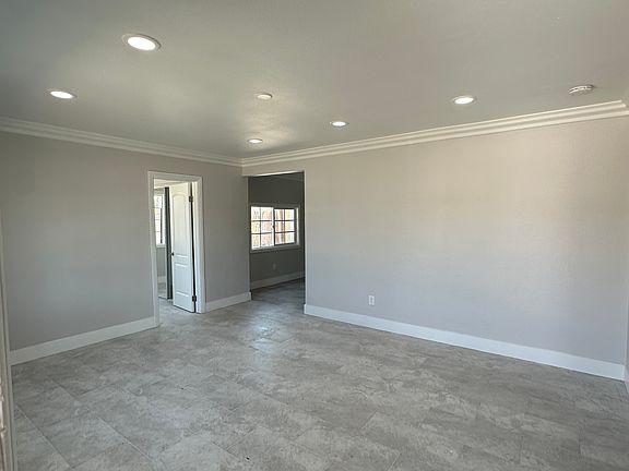 The living room with recessed lighting - creating a bright and welcoming atmosphere