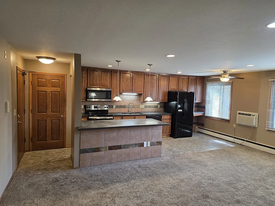 Unit #102 open concept kitchen living room Large Windows.