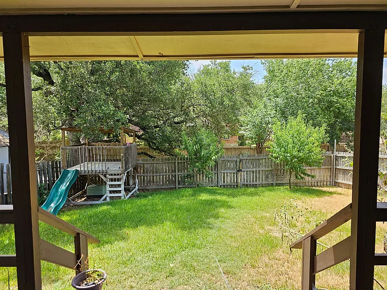Covered deck overlooking back yard and greenbelt