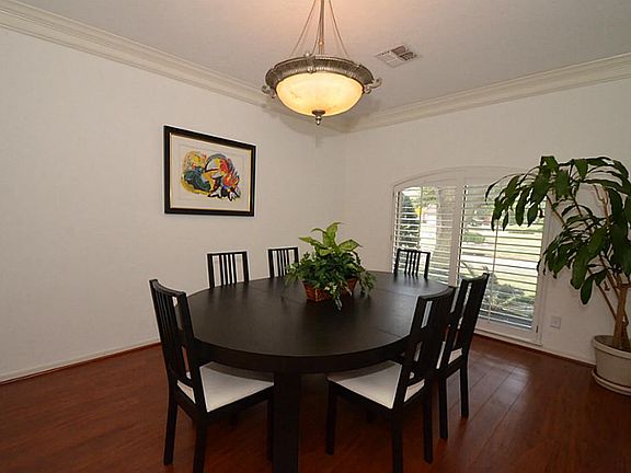 The formal dining boasts of space for additional dining furniture such as China cabinet or buffet table! The room features wood floors and crown molding!