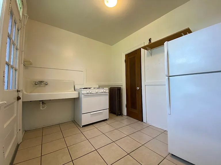 The kitchen offers a practical and efficient layout, seamlessly blending into the apartment's open floor plan while providing ample storage for everyday living.