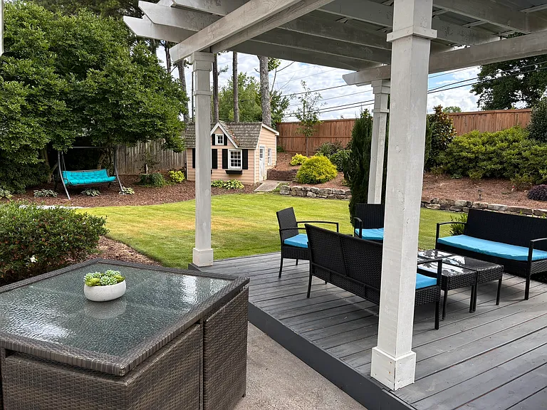 Back yard is fully fenced in with ample seating and grill