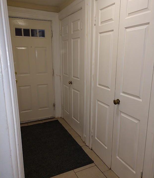 Private hallway entrance with coat closet. Dedicated Ring security system for apartment.
