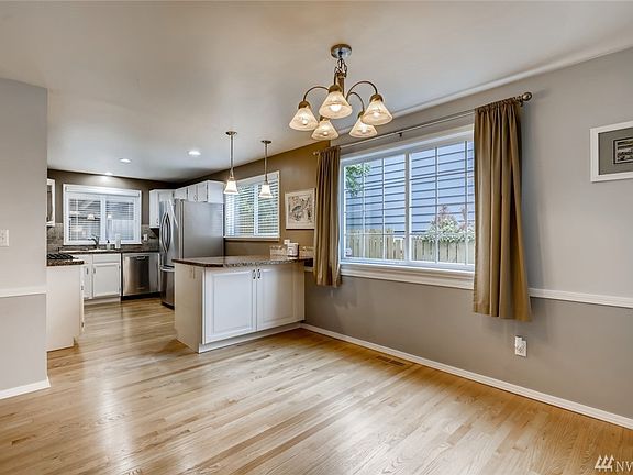 Dining room with beautiful hardwood floors and tons of natural lighting! 