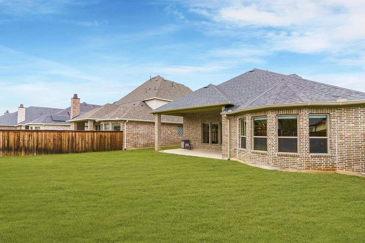 Relax or serve your favorite barbecue on the covered patio. Plenty of yard space for exercise too. - 2817 Amesbury