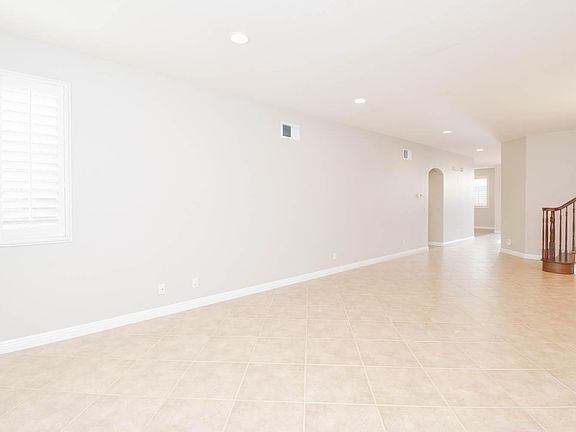 View of the staircase and the hallway leads to downstairs bedroom and bathroom from the living room.