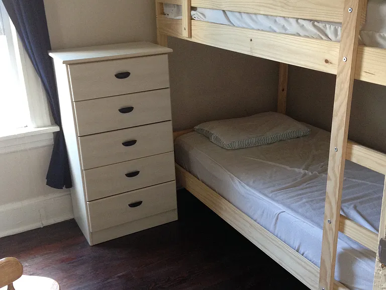 2nd floor east bedroom - show with a bunk bed and small dresser.