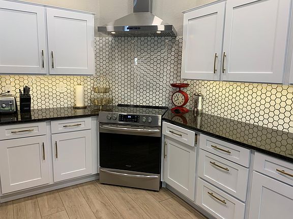 Kitchen with new stainless steel appliances with bonus air fryer in oven.