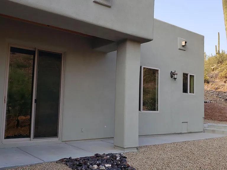 Private back patio that is being extended to allow a table and chairs