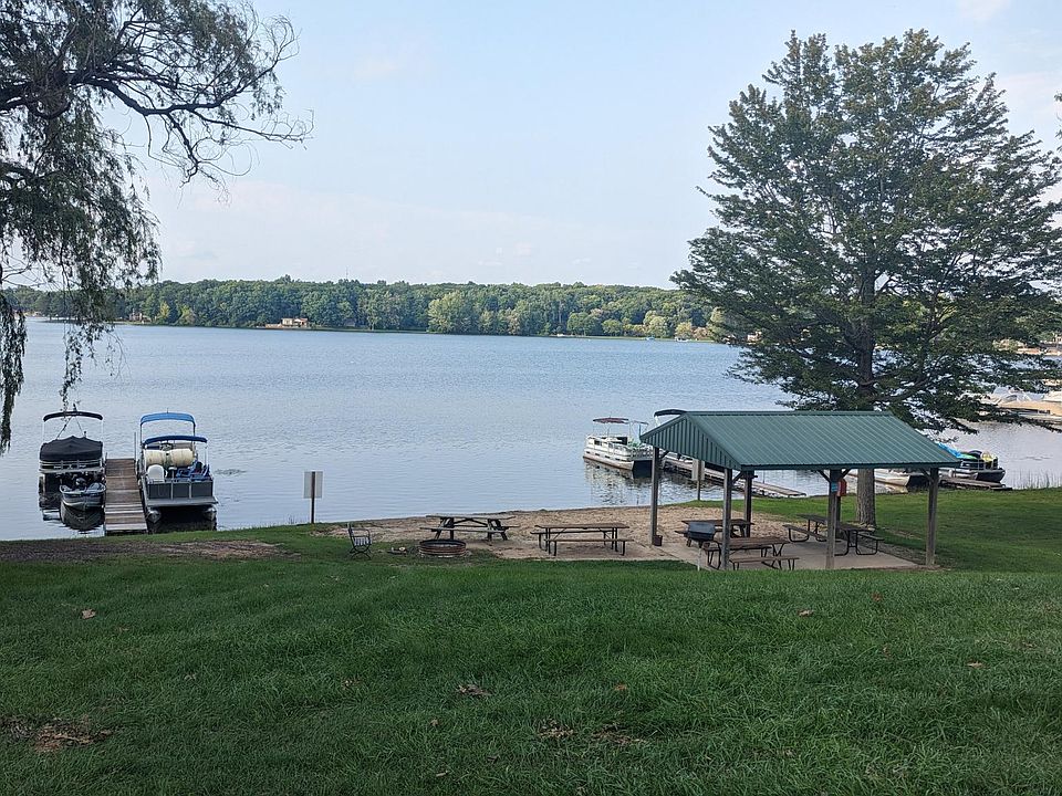 Private community beach with picnic tables, grills, and possible boat docking