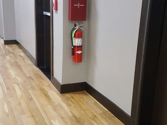 Hallway with Safety FIRE EXTINGUISHERS & 24/7 building fire monitoring.