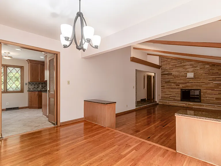 View from dining room area looking out onto the living room space with pristine natural hardwood floors