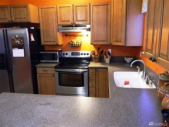 Excellent working space in the kitchen with stainless appliances and solid surface counters.