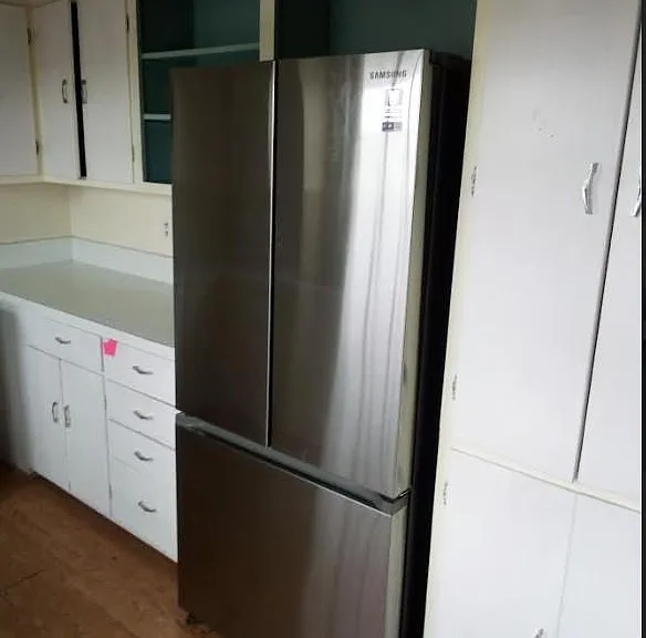 Kitchen with new refrigerator.