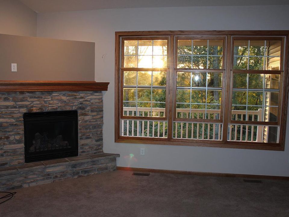 Gas Fireplace in LR. View of the deck and park reserve through the west windows in the evening.