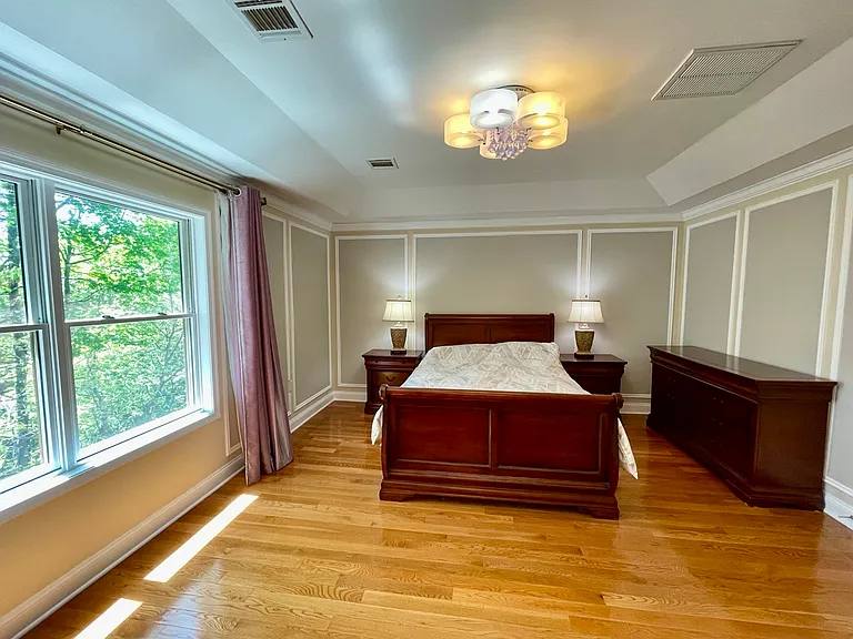 Serene primary bedroom offering space, comfort, and natural light