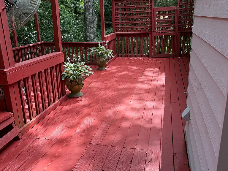 Large back deck overlooking wooded lot